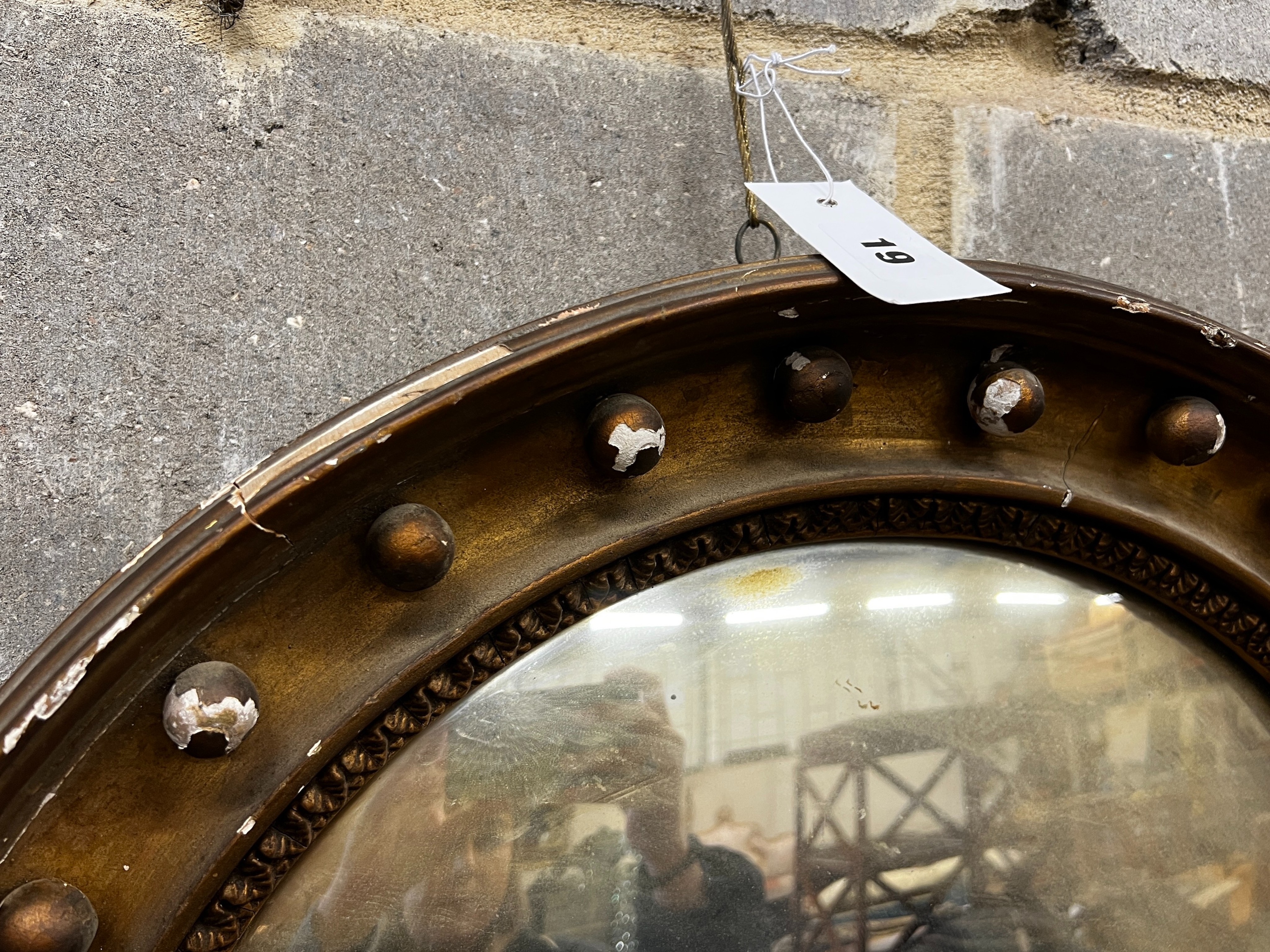 A Regency giltwood convex wall mirror in need of repair, diameter 56cm